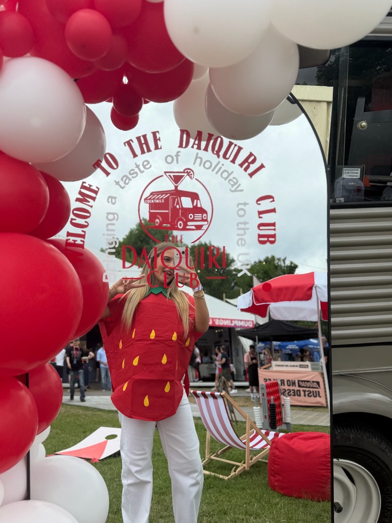 Welcome to The Daiquiri Club arch with balloons at a festival