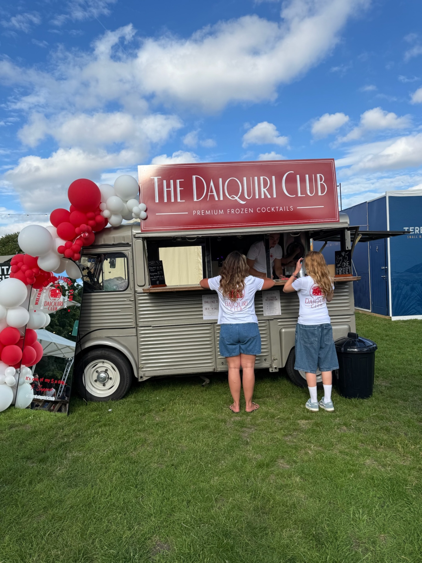 The Daiquiri Club van under a bright blue sky with balloon arch