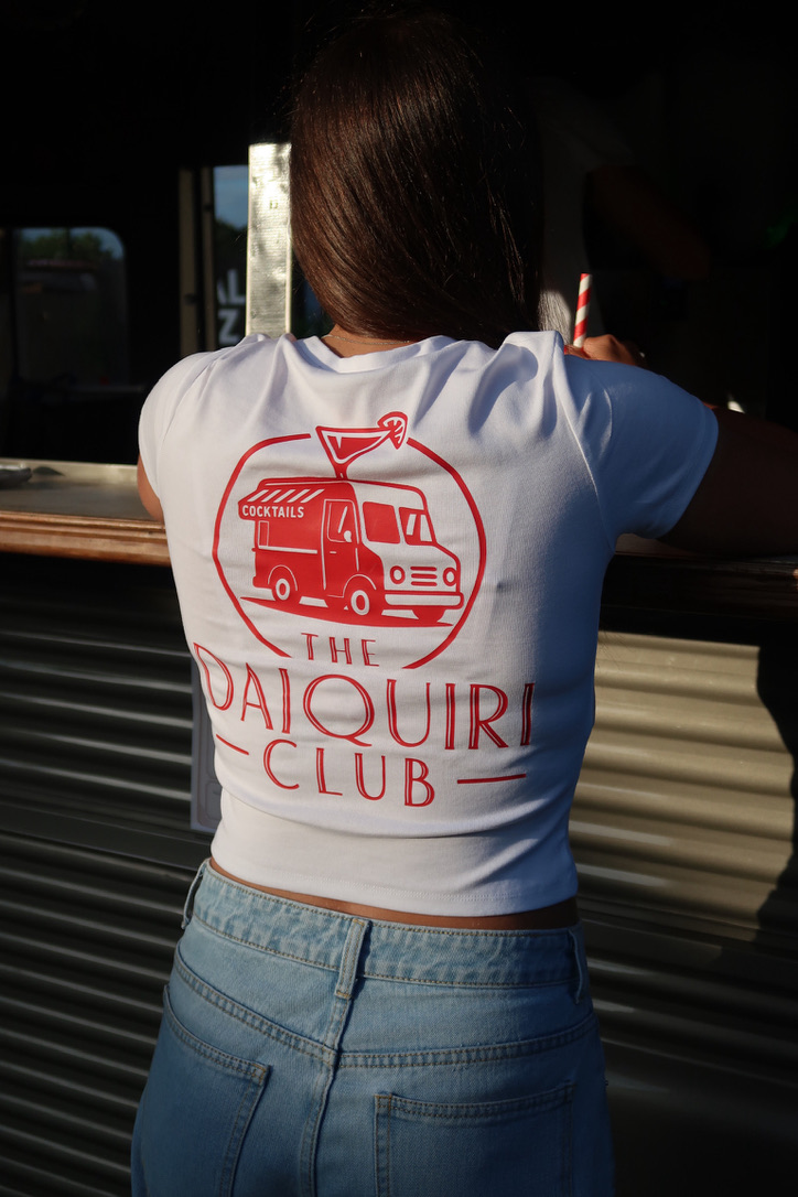 Back of a Daiquiri Club tee showing the van and cocktail logo at the serving window